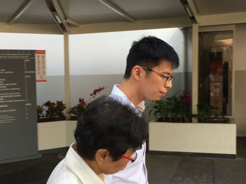 Ng Han Yuan, 25, leaving court with an unknown lady on Friday (Nov 10) after he was charged with one count of breaching the Official Secrets Act. Photo: Alfred Chua/TODAY