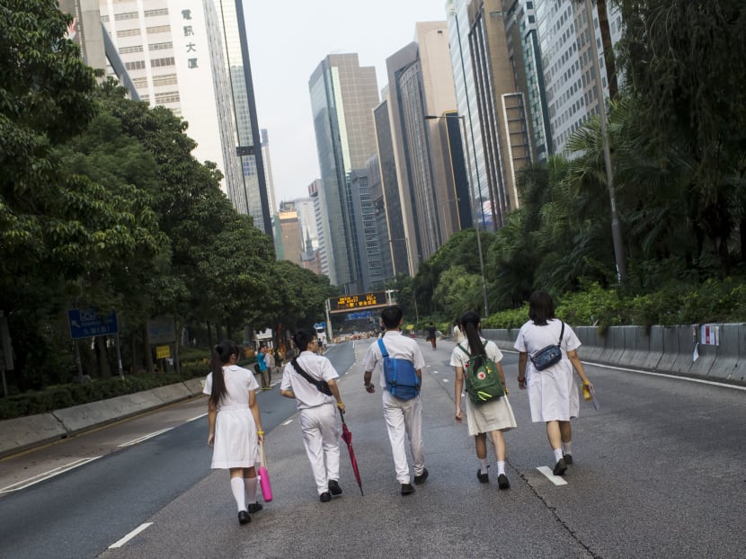 Hong Kong students walking along a main road in the city. All Hong Kong secondary schools will be required to teach Chinese history as an independent compulsory subject at the junior levels from next year, the city’s leader Carrie Lam has announced, in a move that has revived fears of a renewed push for a controversial national education curriculum. Photo: Reuters