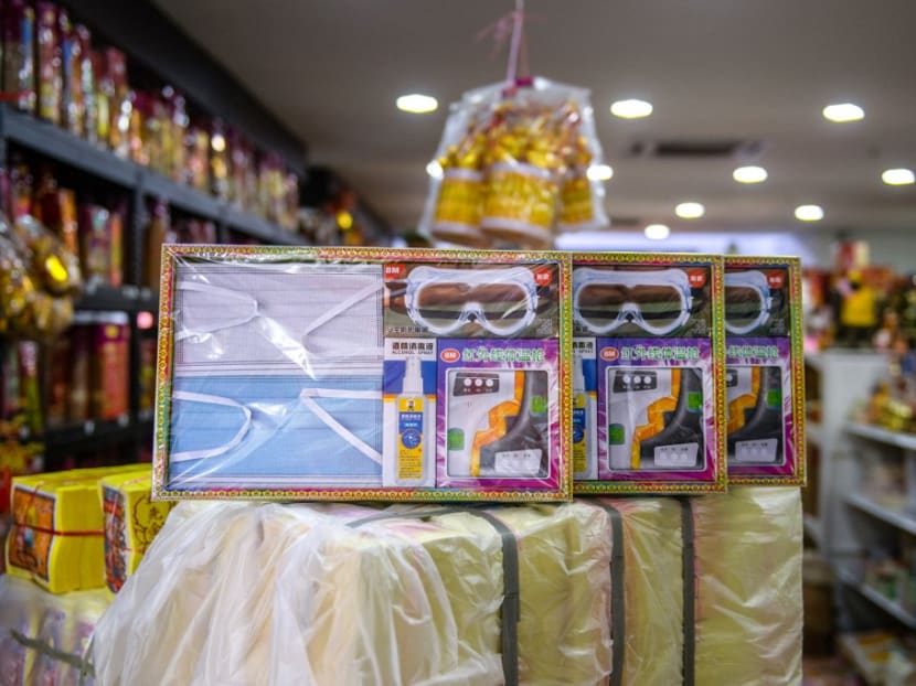 This picture taken on March 22, 2021 shows a set of face masks, goggles, hand sanitiser and thermometer, all made of paper, for sale ahead of the Qingming festival, also known as Tomb Sweeping Day, in Rawang in Malaysia's Selangor state.
