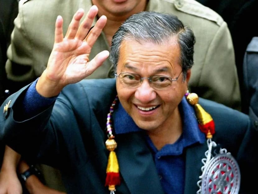 Dr Mahathir Mohamad waves to supporters in Kuala Lumpur in July 2002, a month after his shock resignation as prime minister at the Umno general assembly.