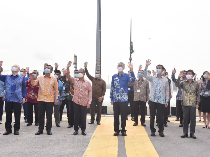 Government officials from Singapore and Malaysia at the Causeway, on July 30, 2020, attending a signing ceremony to resume the Johor Baru-Singapore Rapid Transit System project.