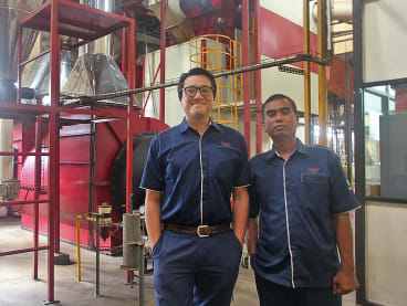 Writer Roy Jr Gan (left) at his company's coffee roasting facility in Surabaya, Indonesia. He is assistant vice-president of productions at PT Aneka Coffee Industry.