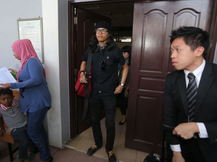 Fahmi Reza (centre) was found guilty of uploading false communication material on his Facebook page with the intention to offend other parties. Photo: The Malay Mail
