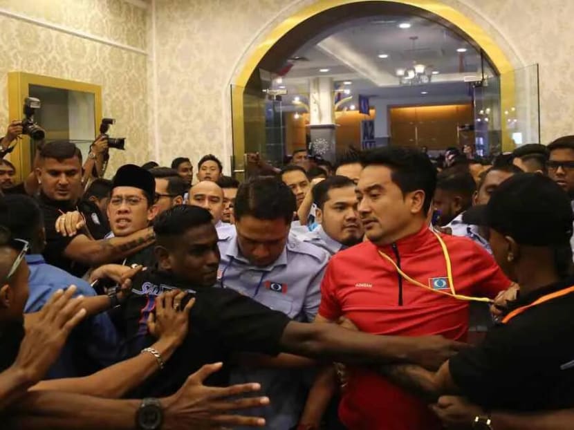 PKR Youth security personnel dressed in black were seen clashing with sacked permanent chairman Mizan Adli Md Noor and others who attempted to force their way into the Classic Ballroom of Melaka International Trade Center in Ayer Keroh.