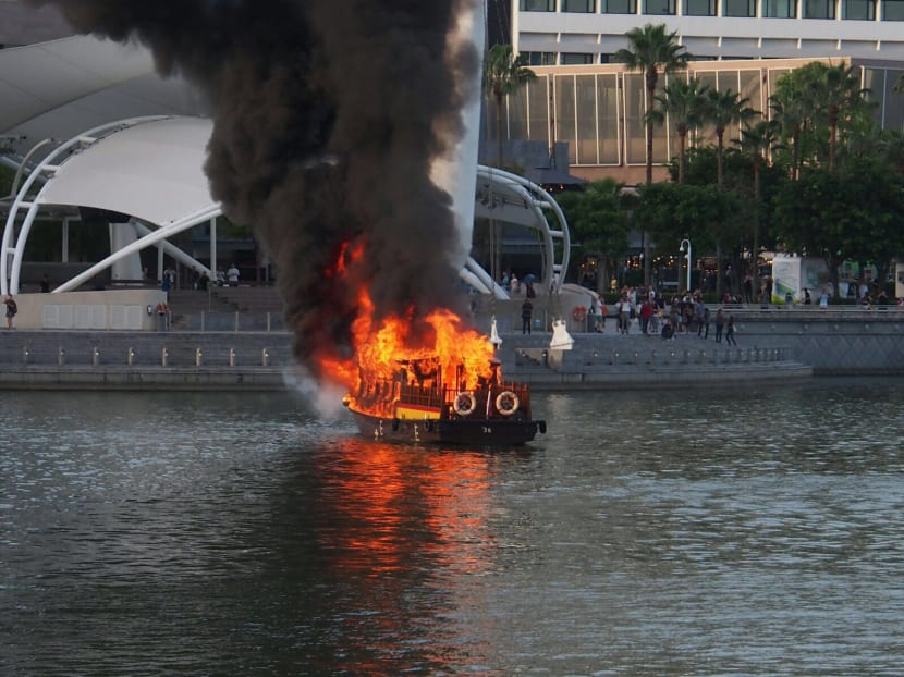 The boat on fire in Marina Bay on Tuesday evening (July 12). Photo submitted by TODAY reader Luke. The boat on fire in Marina Bay on Tuesday evening (July 12). Photo submitted by TODAY reader Luke.