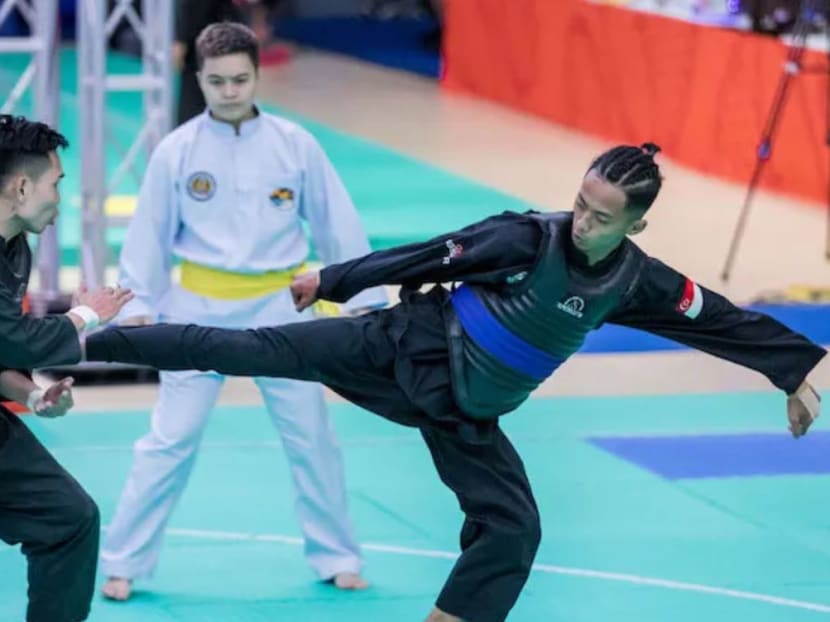 Singapore's Muhammad Hazim (right) wins gold in the men's Tanding Class B silat category at the 2019 SEA Games.