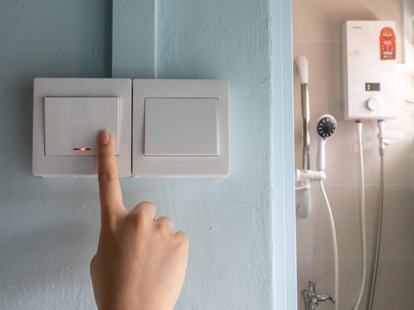 A double pole switch outside a bathroom being pressed for a water heater that is typically installed in public flats. Such switches should be used, electricians said, instead of a power socket for a standard three-pin plug often seen in other home appliances.