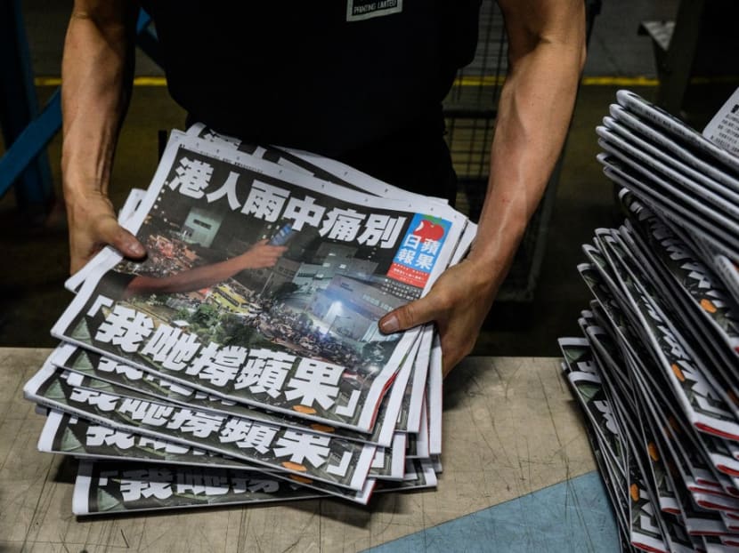 An Apple Daily employee works in the printing room after the last edition of the newspaper is printed in Hong Kong early on June 24, 2021.