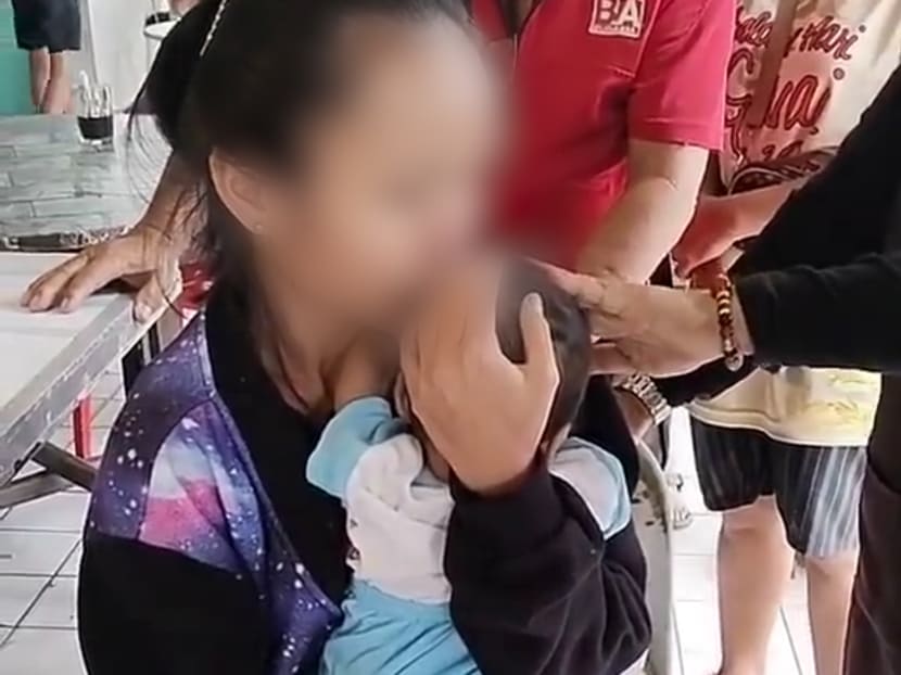 Screenshot from a video showing an unidentified mother cradling her baby who died in a bus in Kuching, Malaysia.