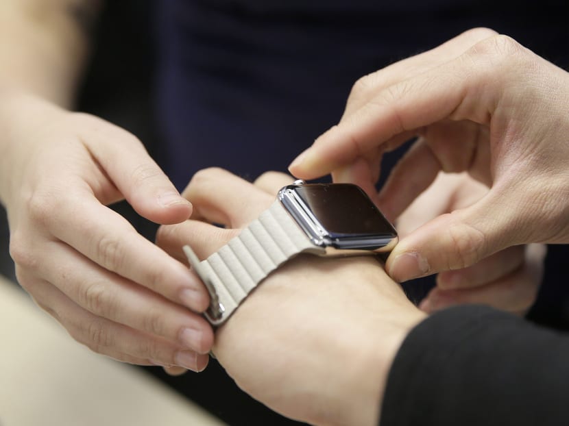 In this Friday, April 10, 2015, file photo, a customer tries on Apple's new watch at a store in San Francisco. Photo: AP