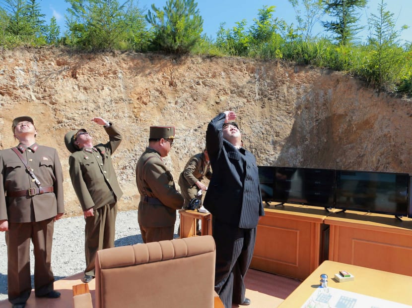 North Korean leader Kim Jong-un and officials  during the test-launch of an intercontinental ballistic missile last week. This missile issue may need strategic thinking similar to the 1962 Cuban missile crisis. Photo: Reuters