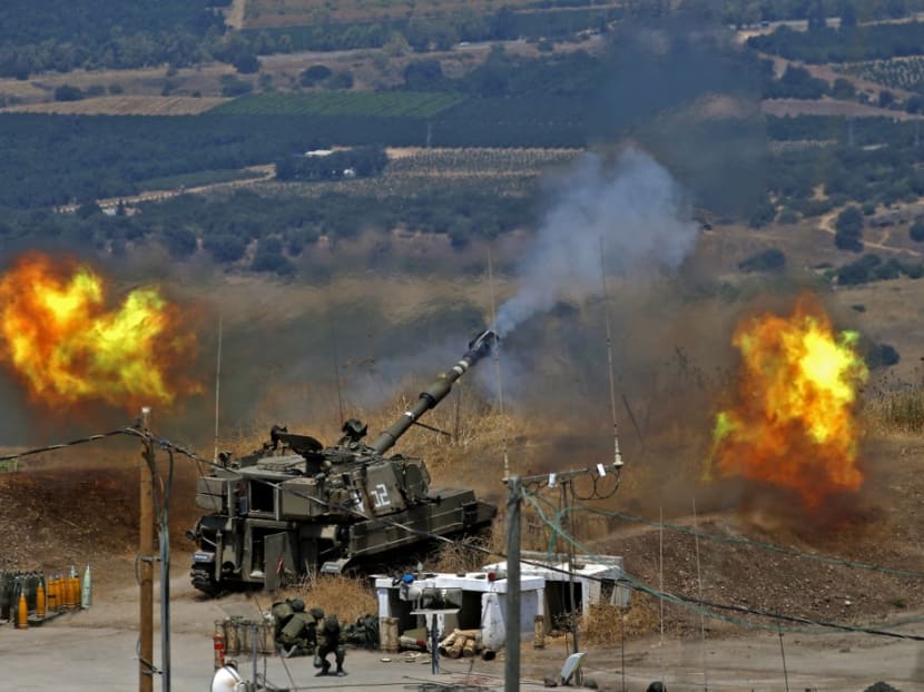 Israeli self-propelled howitzers fire towards Lebanon from a position near the northern Israeli town of Kiryat Shmona following rocket fire from the Lebanese side of the border, on August 6, 2021.