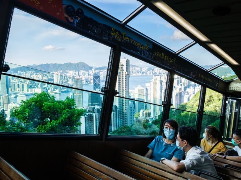 Commuters travel on the Peak Tram down from Victoria Peak in Hong Kong. The travel bubble between Singapore and Hong Kong has been delayed to 2021.