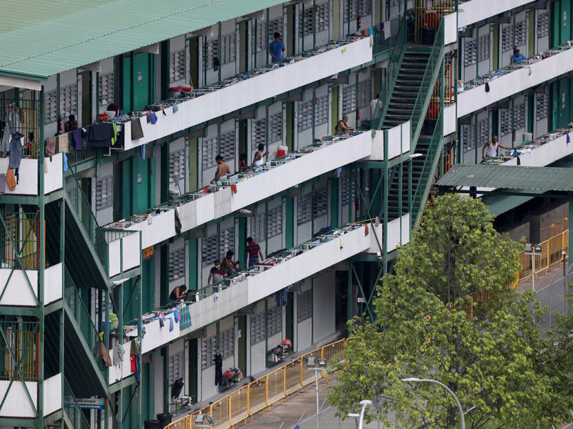 Workers at Cochrane Lodge ll dormitory in Sembawang on April 15, 2020. The dormitory has 46 confirmed cases of Covid-19 and has been gazetted as an isolation area.