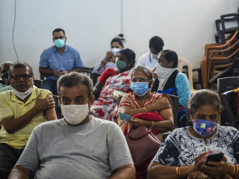 People wait in an observation area after getting inoculated with a dose of the Covishield AstraZeneca-Oxford's Covid-19 coronavirus vaccine at the Rajawadi Hospital in Mumbai on June 22, 2021.