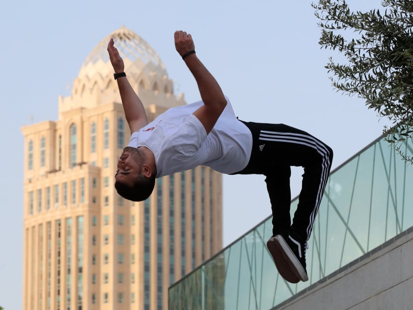 Mr Achref Bejaoui, 25, performs parkour, a sport that originated in France in the 1990s, which involves getting around urban obstacles with a fast-paced mix of jumping, vaulting, running and rolling, in the Qatari capital Doha, on Aug 11, 2020.