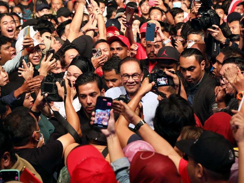 Pakatan Harapan leader Anwar Ibrahim moves among a crowd while campaigning ahead of the General Election at a rally in Tambun, Perak, on Nov 18, 2022. Pakatan Harapan leader Anwar Ibrahim moves among a crowd while campaigning ahead of the General Election at a rally in Tambun, Perak, on Nov 18, 2022.