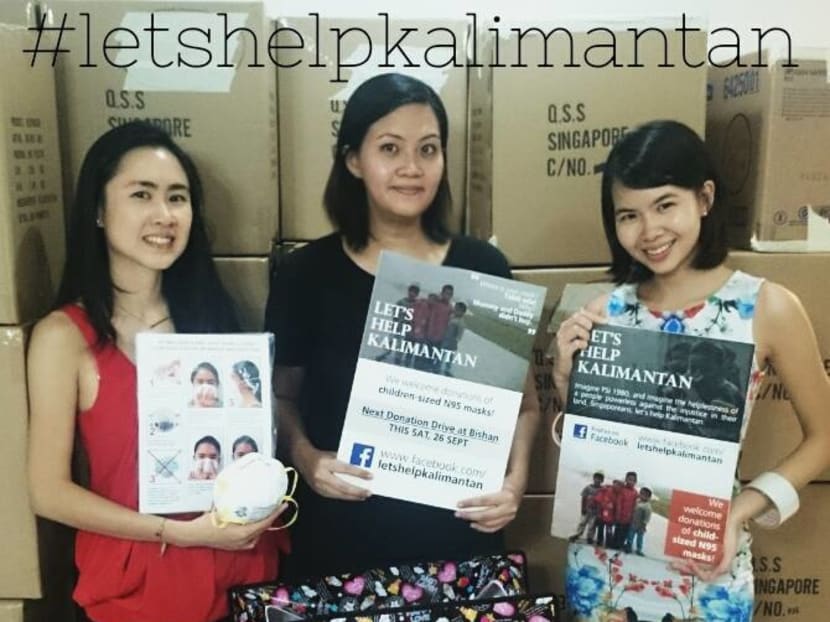 Organisers behind the Let's Help Kalimantan initiative posing in front of boxes of N95 masks. Photo: Let’s Help Kalimantan/Facebook