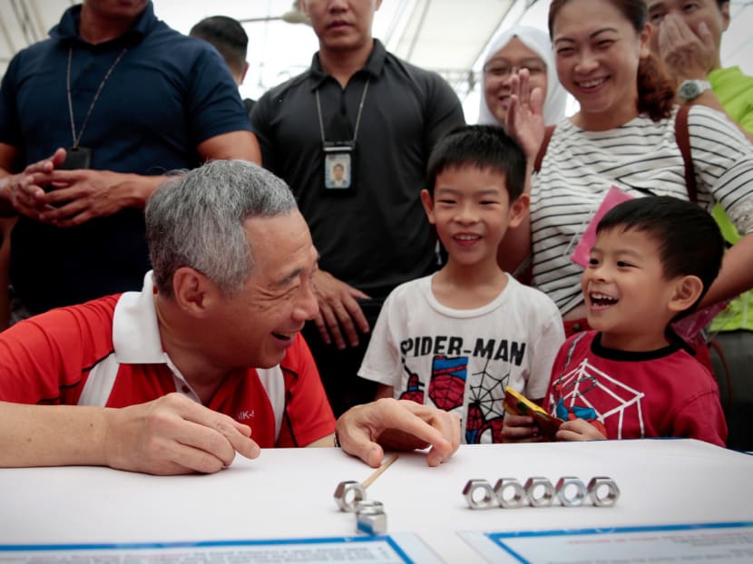 Prime Minister Lee Hsien Loong during Jalan Kayu Day yesterday. A one-time top-up will help some 250 families earning a per capita income of S$950 or less. Photo: Jason Quah