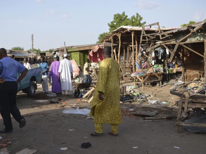 People gather at the site of a suicide bomb attack at a market in Maiduguri, Nigeria, Monday June 22, 2015. Photo: AP