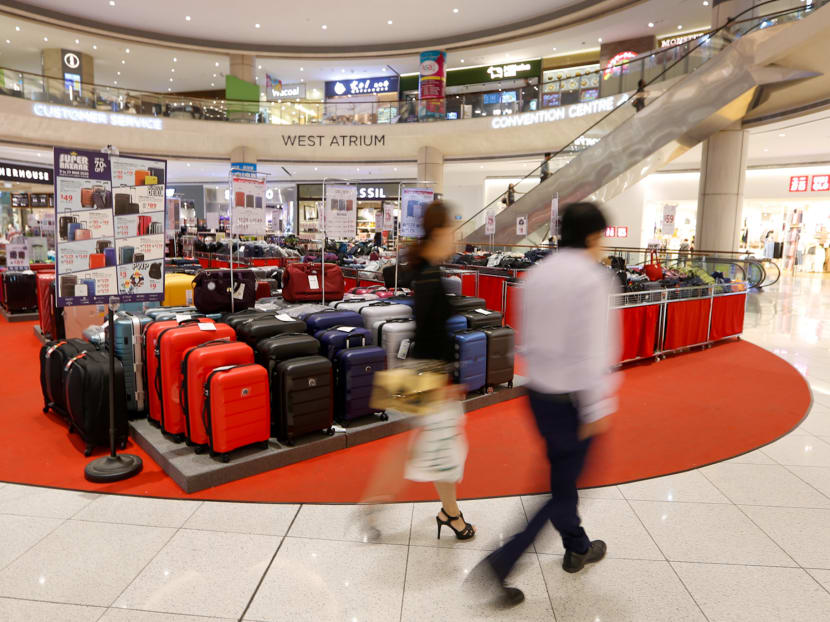 People passing through Suntec City's West Atrium on March 24, 2020. People passing through Suntec City's West Atrium on March 24, 2020.