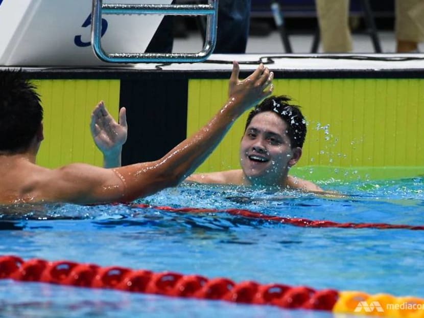 Joseph Schooling celebrates with compatriot Quah Zheng Wen after the 100m butterfly final at SEA Games 2019.