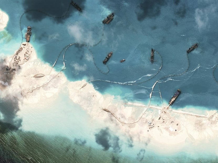 A handout satellite image shows dredgers working at the northernmost reclamation site of Mischief Reef, part of the Spratly Islands, in the South China Sea, March 17, 2015. Photo: CSIS's Asia Maritime Transparency Initiative via The New York Times