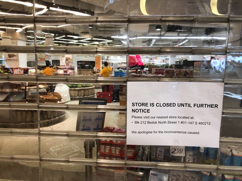 A sign notifying customers of the closure is seen at NTUC FairPrice Finest at Bedok Mall.
