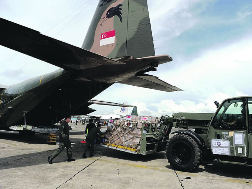 SAF personnel unloading relief supplies from an RSAF C-130 in Tacloban, Philippines. The experience has underscored the need for a JMMS, said Dr Ng. Photo: MINDEF
