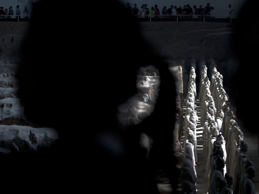 Visitors walk past a display of the unearthed Terra Cotta Warriors in 2013. AP file photo