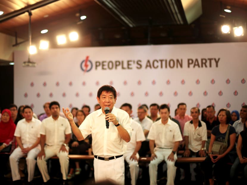 Khaw Boon Wan speaks to Sembawang residents during a 'kopi chat' session as his fellow candidates for Sembawang GRC on August 14, 2015. Photo: Jason Quah