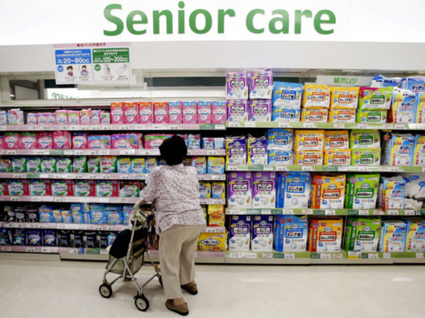 A shopper looking at adult diapers sitting on a display shelf at a shopping centre in Tokyo. Japan’s aged-care infrastructure is not up to the task of supporting a looming surge of ageing baby-boomers. Photo: Reuters