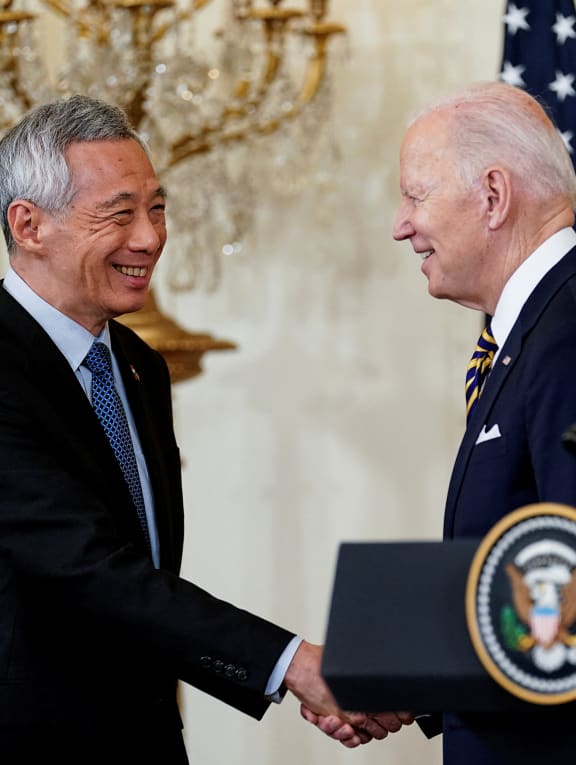 US President Joe Biden greets Singapore's Prime Minister Lee Hsien Loong during a joint news conference in the East Room at the White House in Washington, US, on March 29, 2022.
