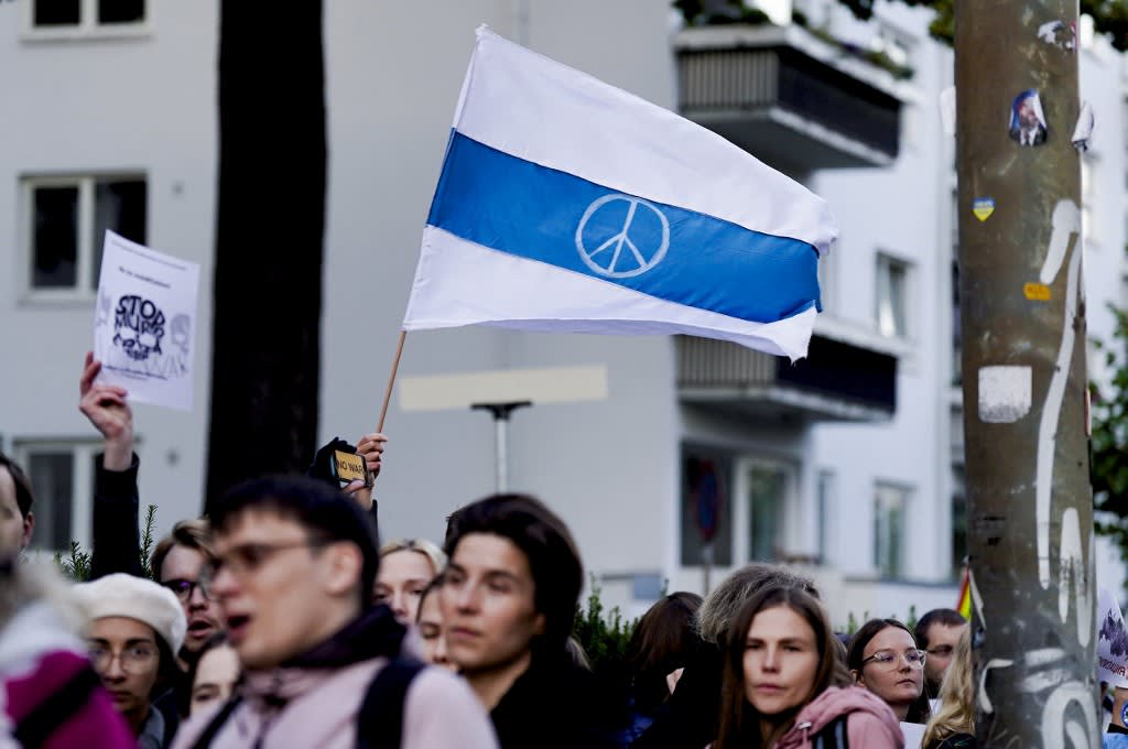Protesters hold up a white-blue-white anti-war flag, said to be a symbol of opposition to the 2022 Russian invasion of Ukraine, as they demonstrate in front of the Russian Embassy in Oslo, Norway on Sept 21, 2022. Protesters hold up a white-blue-white anti-war flag, said to be a symbol of opposition to the 2022 Russian invasion of Ukraine, as they demonstrate in front of the Russian Embassy in Oslo, Norway on Sept 21, 2022.