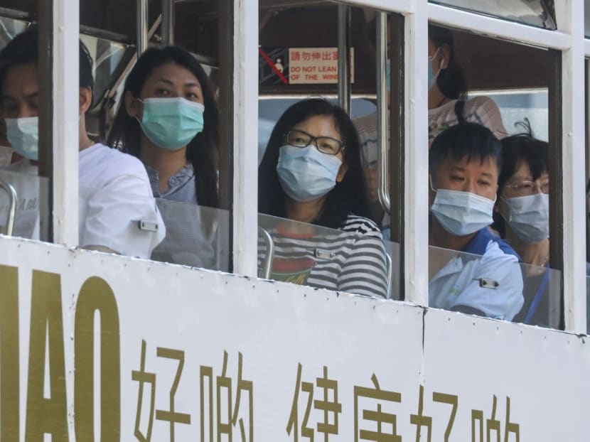 Passengers on a tram in Hong Kong wear masks to guard against the coronavirus. Passengers on a tram in Hong Kong wear masks to guard against the coronavirus.