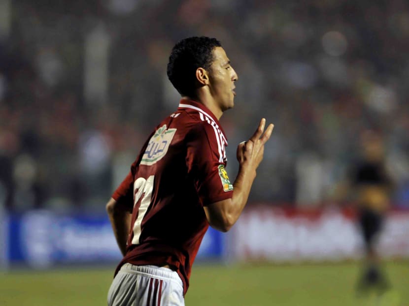 Egyptian Al Ahly player Ahmed Abdul Zaher appears to make a four-fingered hand signal after scoring a goal, a gesture that is linked with support for ousted Islamist president Mohammed Morsi, during the African Champions League second leg final match against South Africa's Orlando Pirates in Cairo on Nov 10, 2013. Photo: AP