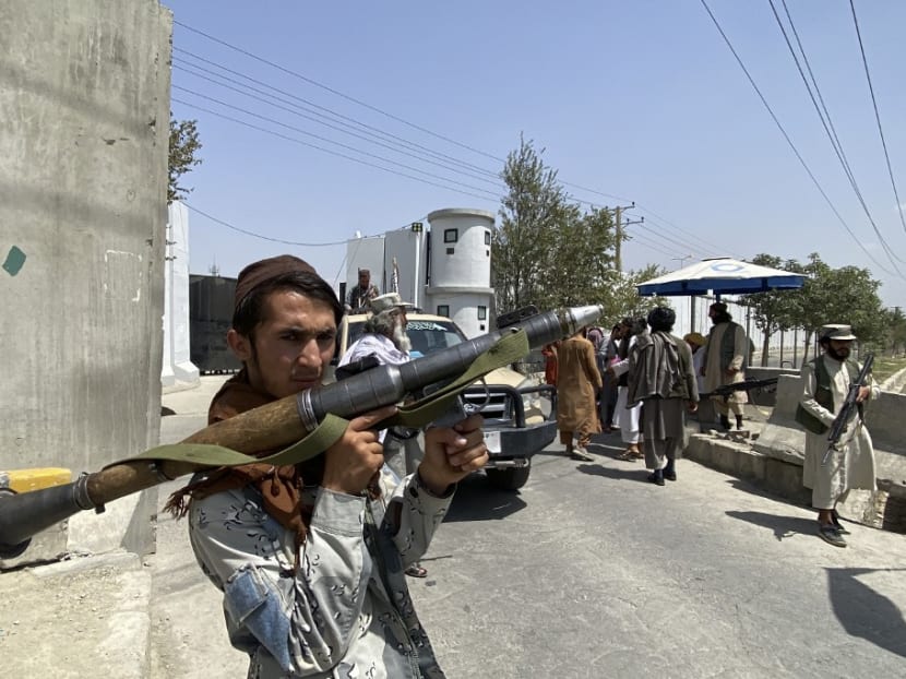A Taliban fighter holds RPG rocket propelled as he stands guard with others at an entrance gate outside the Interior Ministry in Kabul on Aug 17, 2021.