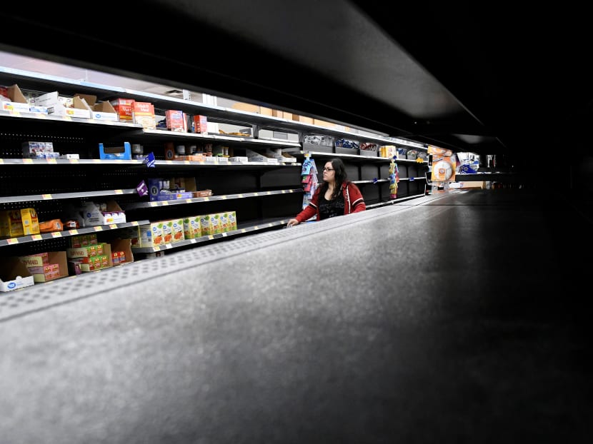 A woman shops for last minute supplies while shelves remain empty as Hurricane Lane approaches Honolulu. A woman shops for last minute supplies while shelves remain empty as Hurricane Lane approaches Honolulu.
