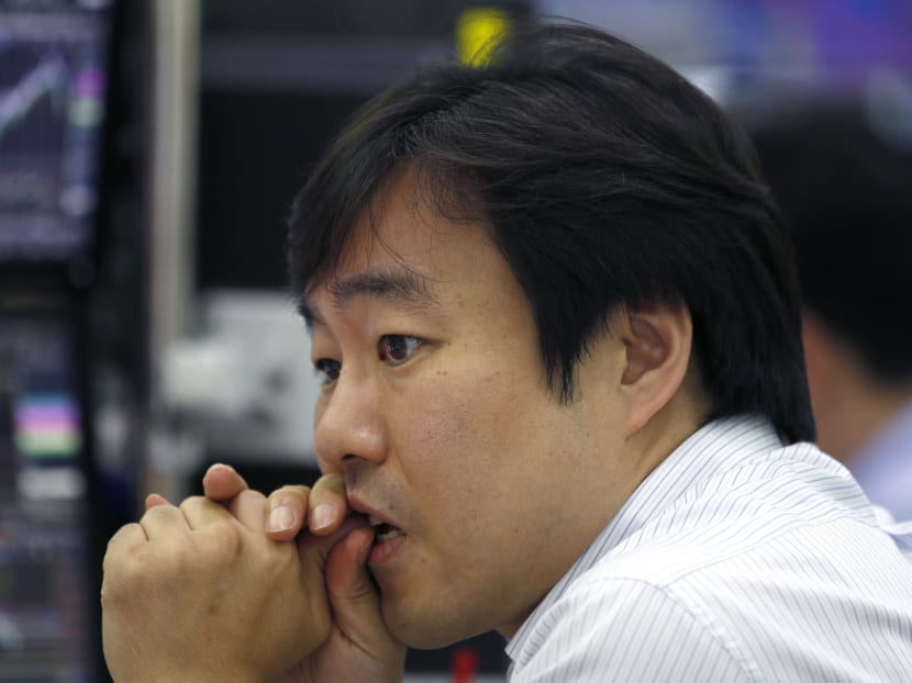 A currency trader watches monitors at a foreign exchange dealing room. AP file photo