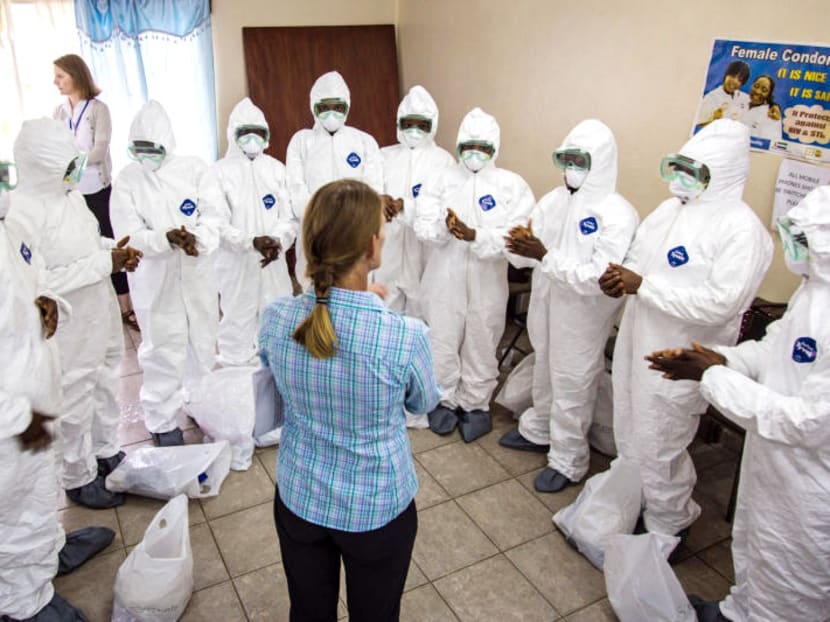 A WHO worker (centre) training nurses to use Ebola gear in Sierra Leone. Photo: AP