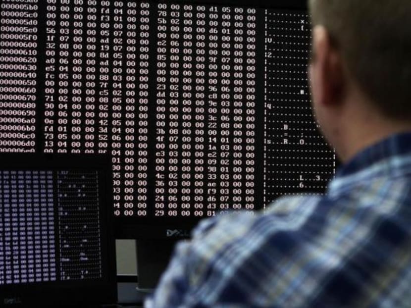 An analyst looks at code in the malware lab of a cyber security defence lab at the Idaho National Laboratory. The author says that recent cyber attacks show how seemingly legitimate network users can create vulnerabilities that security tools miss. Photo: Reuters