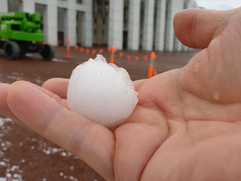 A hail stone is seen outside the Parliament House in Canberra after a storm.