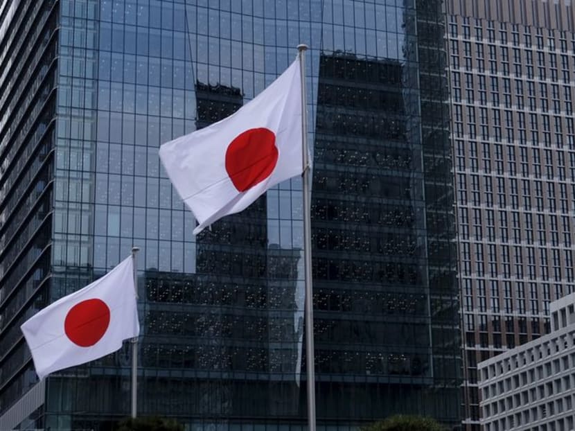 Japanese national flags flutter in front of buildings at Tokyo's business district in Japan, on Feb 22, 2016.