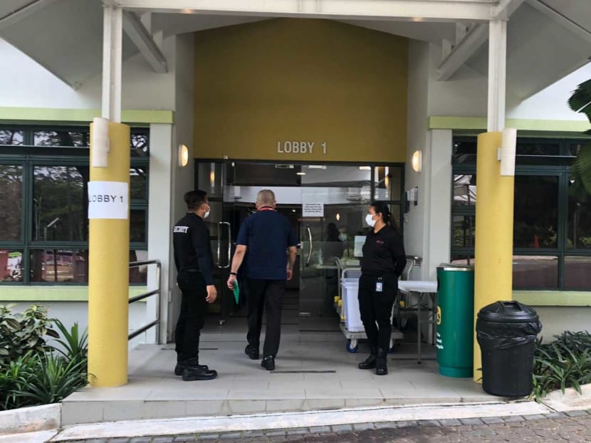 Security officers outside the entrance of Graduate Hall 1 at Nanyang Technological University which has been converted to a quarantine facility.