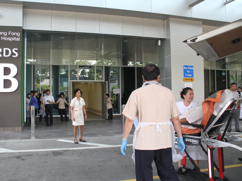 Paramedics wheeling a patient from Alexandra Hospital into the new Ng Teng Fong Hospital. Photo: Jaslin Goh