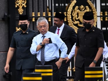 Malaysia's king, Sultan Abdullah Sultan Ahmad Shah (second from right), walking to meet members of the media outside the National Palace in Kuala Lumpur on Nov 21, 2022. 