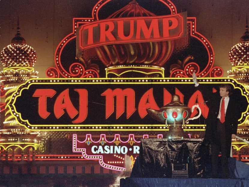In this April 5, 1990 file photo, Donald Trump stands next to a genie lamp as the lights of his Trump Taj Mahal Casino Resort light up the evening sky marking the grand opening of the venture in Atlantic City, NJ. Photo: AP