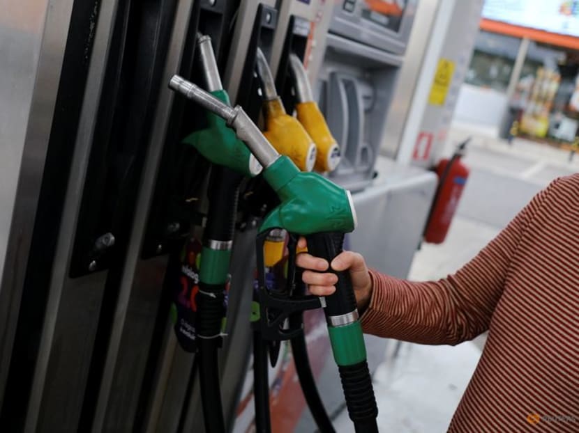 A person uses a petrol pump, as the price of petrol rises, in Lisbon, Portugal, March 7, 2022. Picture taken March 7, 2022. REUTERS/Pedro Nunes/File Photo