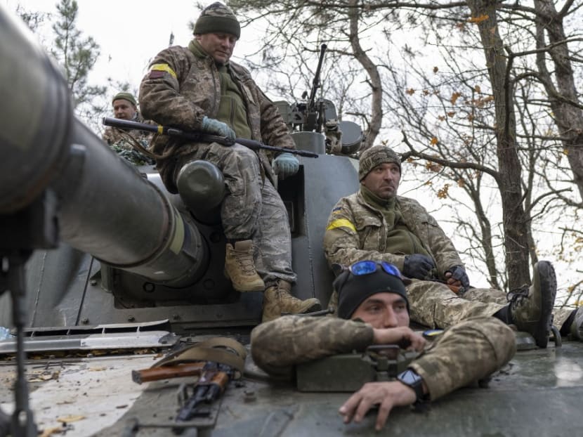 Ukrainian artillery unit members get prepared to fire towards Kherson on Oct 28, 2022, outside of Kherson region, amid Russia's military invasion on Ukraine.
