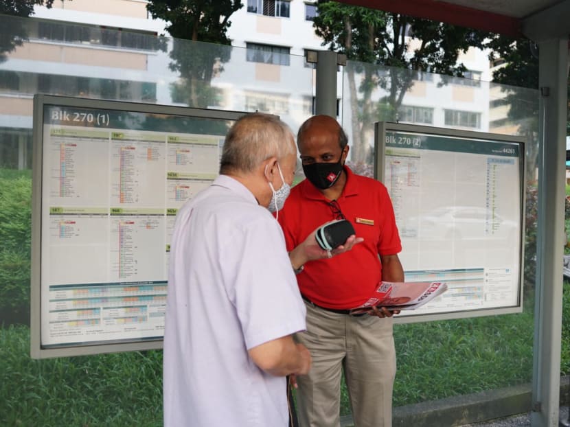 Dr Paul Tambyah (right) from the SDP distributes flyers to residents at a bus stop at Block 270, Bangkit Road on July 6, 2020.